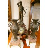 A French striking mantel clock with spelter figure mount in rouge marble and gilt metal case