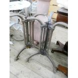 A pair of heavy iron tripod table stands