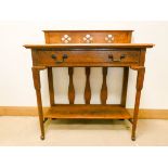 An Arts and Crafts style oak two tier side table fitted one long drawer on turned legs 3' wide