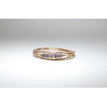 Edwardian 9ct gold ladies bangle, inset with a panel of sapphires,