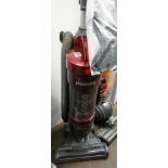 A red and silver upright vacuum cleaner