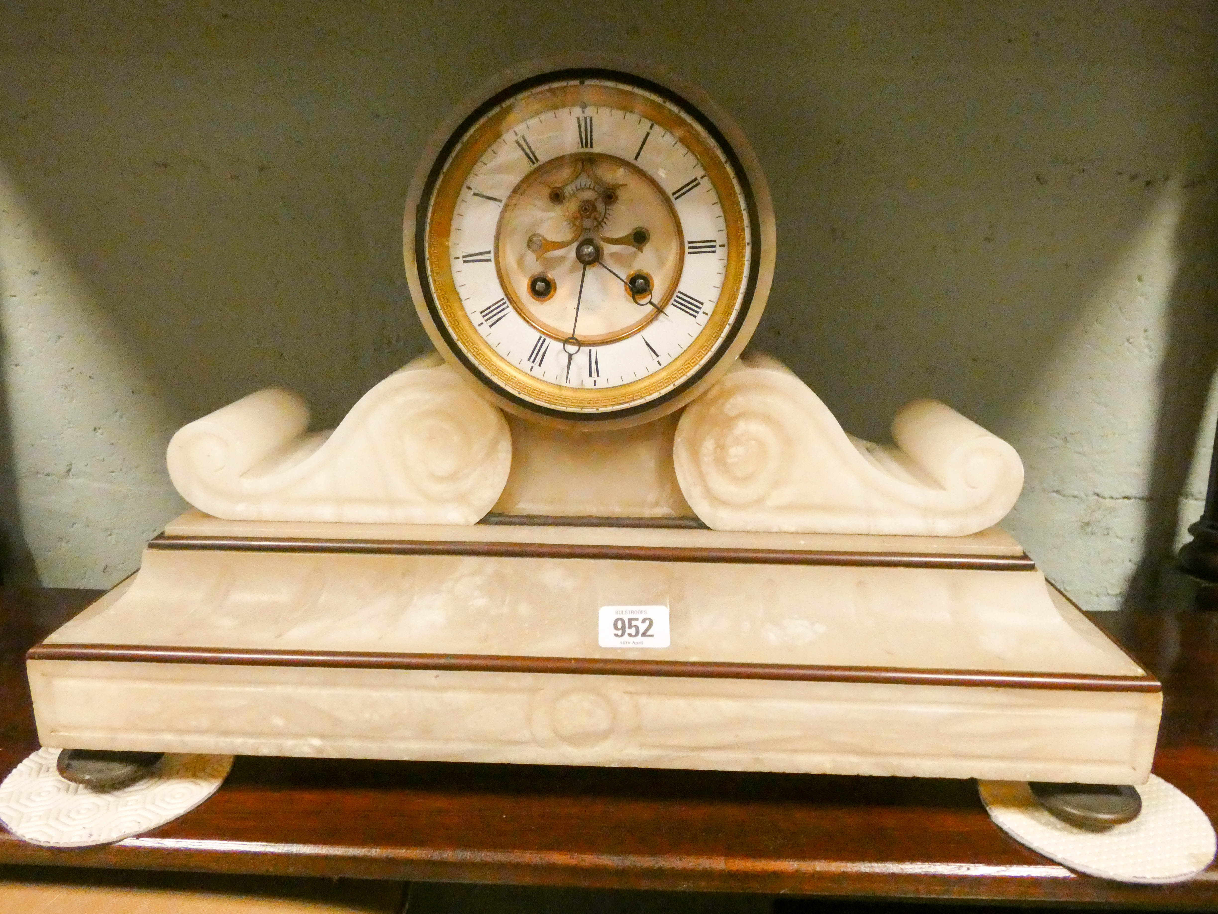 A French striking mantel clock in a white alabaster case 13 1/2" high,