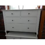 A modern cream painted chest of two long and two short drawers matching the previous dressing table