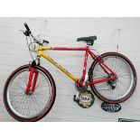 A red and yellow Claude Butler gents bicycle with front suspension