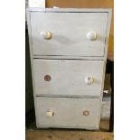 A cream painted pine chest of three deep drawers 2' wide