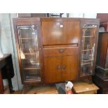 A walnut side by side bureau cabinet with drawer and cupboards under 4' wide