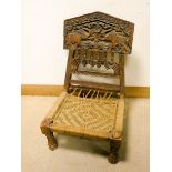 An Indian Elephant carved wood folding low seat chair with string seat