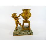 A French gilt metal novelty ink well modeled as a cherub at an easel on a rectangular green veined