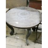 An Indian circular carved occasional table on cabriole shaped legs