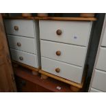 A modern pine three drawer bedside chest and a pine and cream three drawer chest