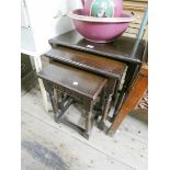 A nest of three reproduction oak coffee tables