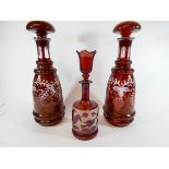 A collection of three Bohemian and flash glass decanters,