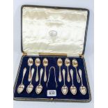A boxed set of twelve hallmarked silver teaspoons and matching sugar nips in fitted box