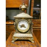 A French striking mantel clock by Japy Freres in decorative brass case with urn shaped finial