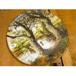 A Victorian circular wall plate painted with a landscape scene 16" diameter