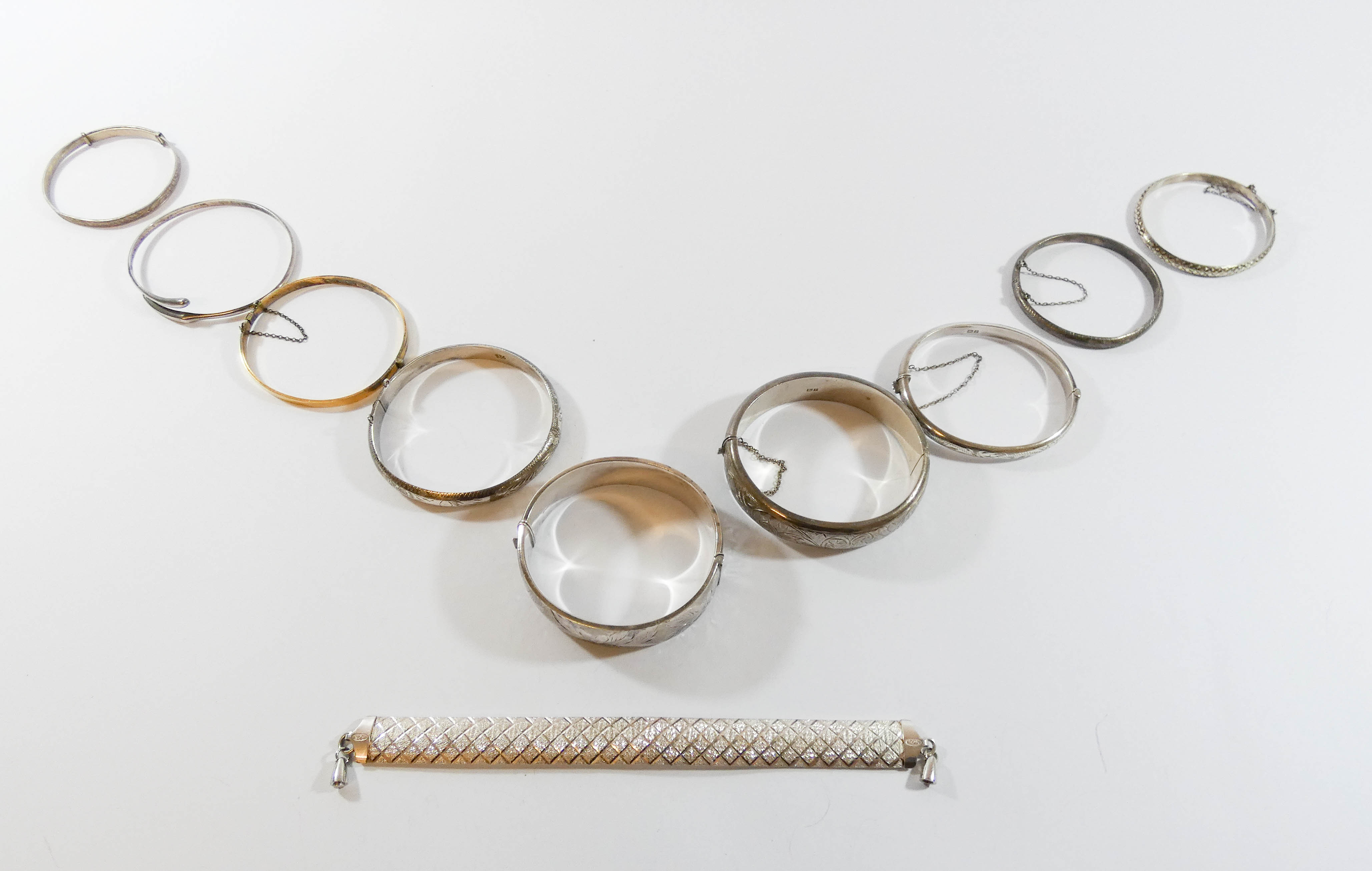 A collection of ten silver bangles and bracelets,