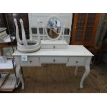A modern cream painted kneehole dressing table fitted three drawers standing on cabriole legs
