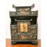 A Chinese black lacquered bird and floral decorated trinket box fitted numerous drawers and