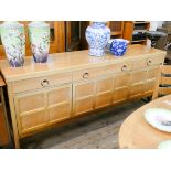 A Nathan pale teak long low sideboard fitted three drawers,