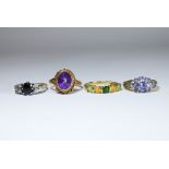 A collection of four ladies 9ct gold dress rings set with various gem stones.
