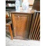 An oak bedside cabinet with interior shelves