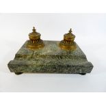 A 19th Century French gilt brass and marble desk stand, fitted two ink wells with liners,