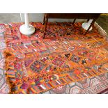 A multi-coloured double saddlebag style Persian rug decorated with camels,