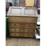 A Georgian style oak bureau with well fitted interior along with well and three long drawers under,