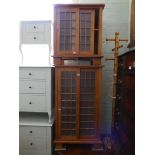 A pine cabinet with two sliding doors and a similar smaller one