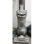 A silver and red Dyson ball upright vacuum cleaner