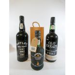Two 75cl bottles of vintage port together with a 375ml bottle Sandeman's port in its original pine
