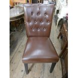 A set of four brown leather studded dining room chairs