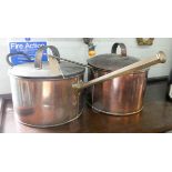 Two large Victorian copper saucepans complete with lids with brass handles,