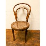 A child's Bentwood chair with cane seat