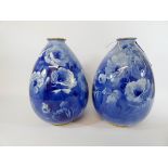 A pair of Doulton Burslem Corolian ware, blue white and gilt floral design vases of ovoid form,