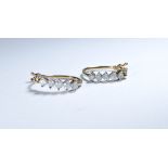 Pair of diamond hoop earrings, each set five brilliant cut diamonds on 9ct gold settings.