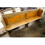 A stained pine church pew 7' long