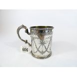 A silver christening mug decorated with swags of flowers and garlands with beaded border,