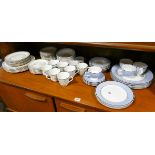 A blue bordered dinner and tea service and a floral decorated dinner and tea set
