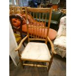 A late Georgian simulated Rosewood spindle back elbow chair with cream upholstered seat