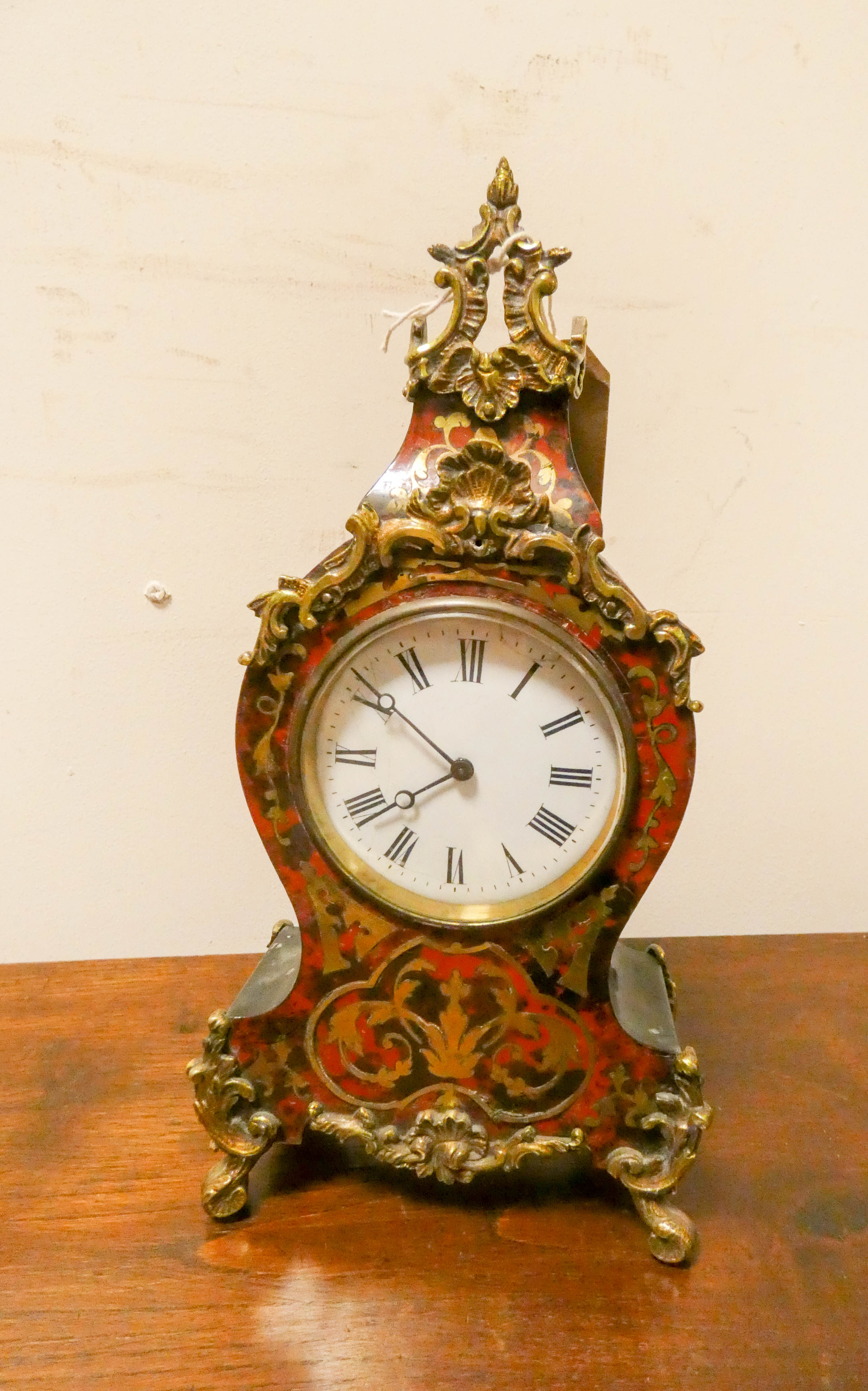 A Buhl brass mounted mantel clock with white enamel dial 12" tall