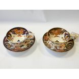 A pair of Imari style porcelain cabinet cups and saucers,