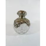 A Victorian cut glass and silver mounted scent bottle with stopped and lid,