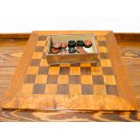 A mahogany chess board and Bakelite chess pieces