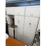 A cream and gilt decorated two section wardrobe unit, fitted hanging space,