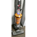 A yellow and silver Dyson ball upright vacuum cleaner