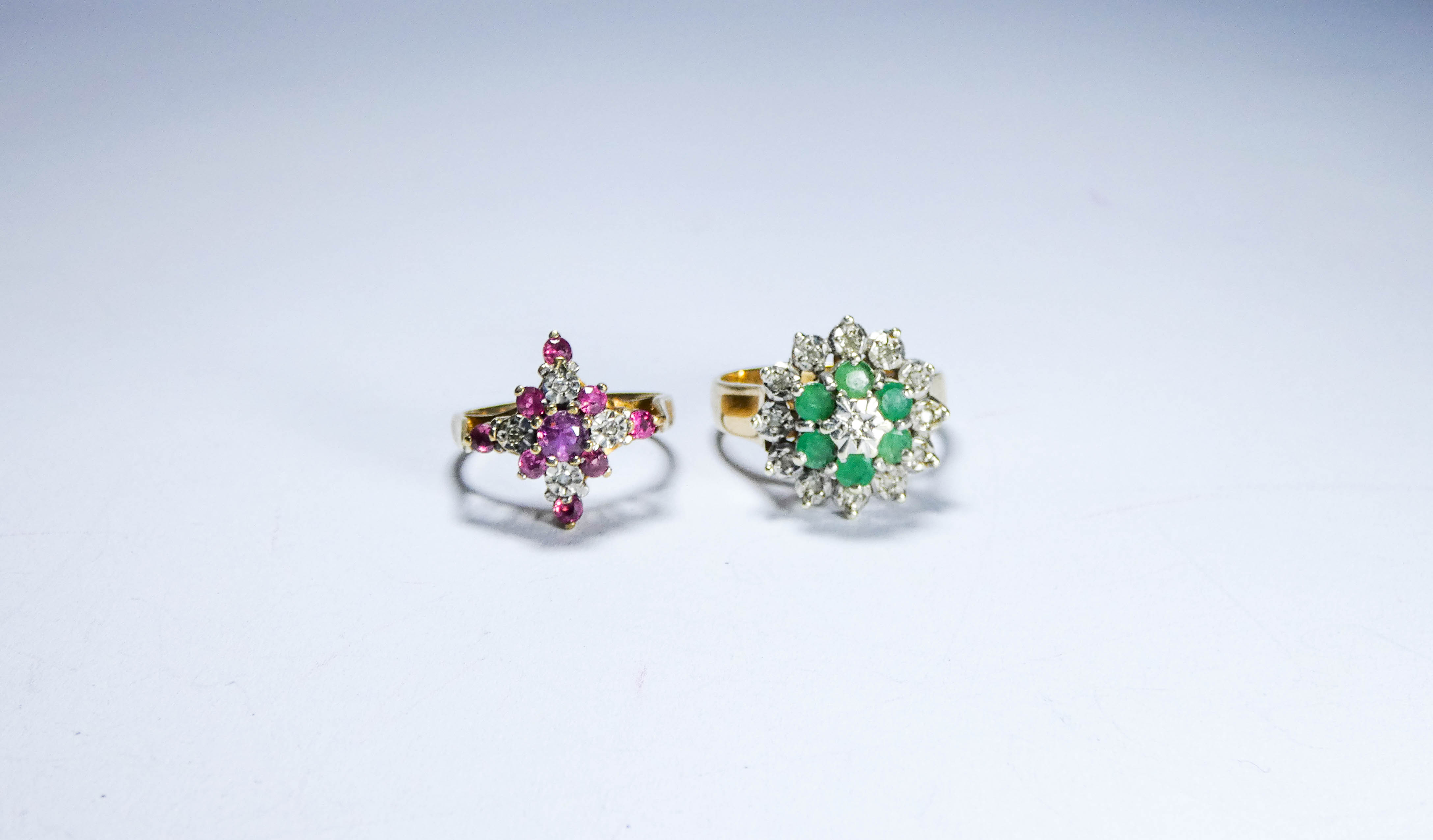 Two 9ct gold ladies dress rings one set with emeralds the other with rubies,