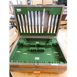 A walnut cutlery cabinet fitted drawer and a circular embossed brass tray