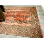 A large red and patterned Turkish wool pile rug approx 10' x 7'