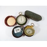 Two travelling pocket barometers in their original cases together with a brass tobacco box inlaid